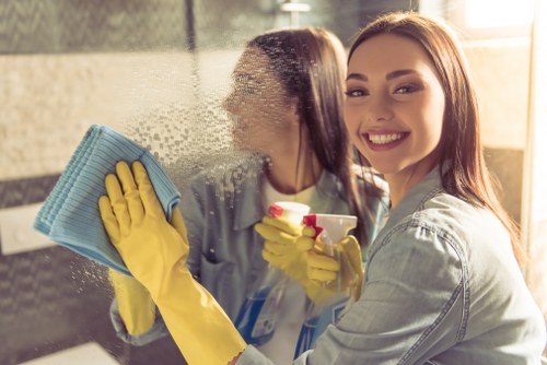 Local oven cleaner removing baked-on grease from an oven door in SW18