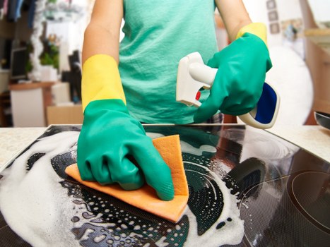 Domestic cleaner tidying a modern flat in SW18