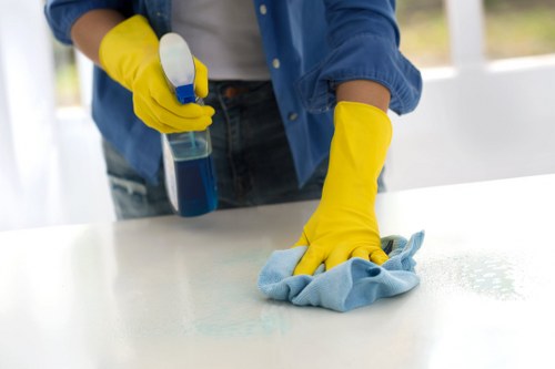 Technician treating fabric chairs during upholstery cleaning